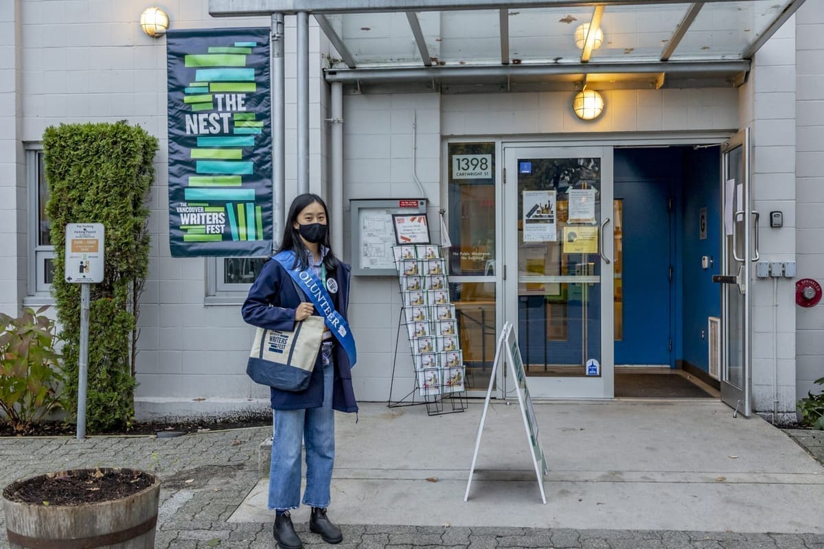 A Festival volunteer outside The NEST on Granville Island
