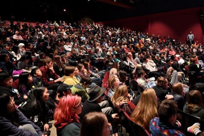 A packed Festival audience in a theatre
