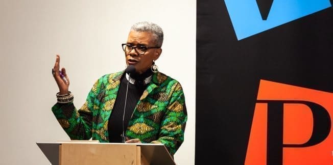 An author speaks at a podium at the Vancouver Public Library